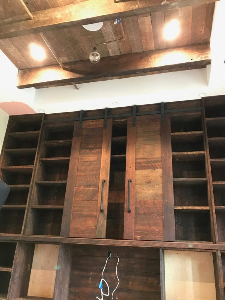 Office reclaimed wood Cabinets and buil-in book shelves with sliding ladder